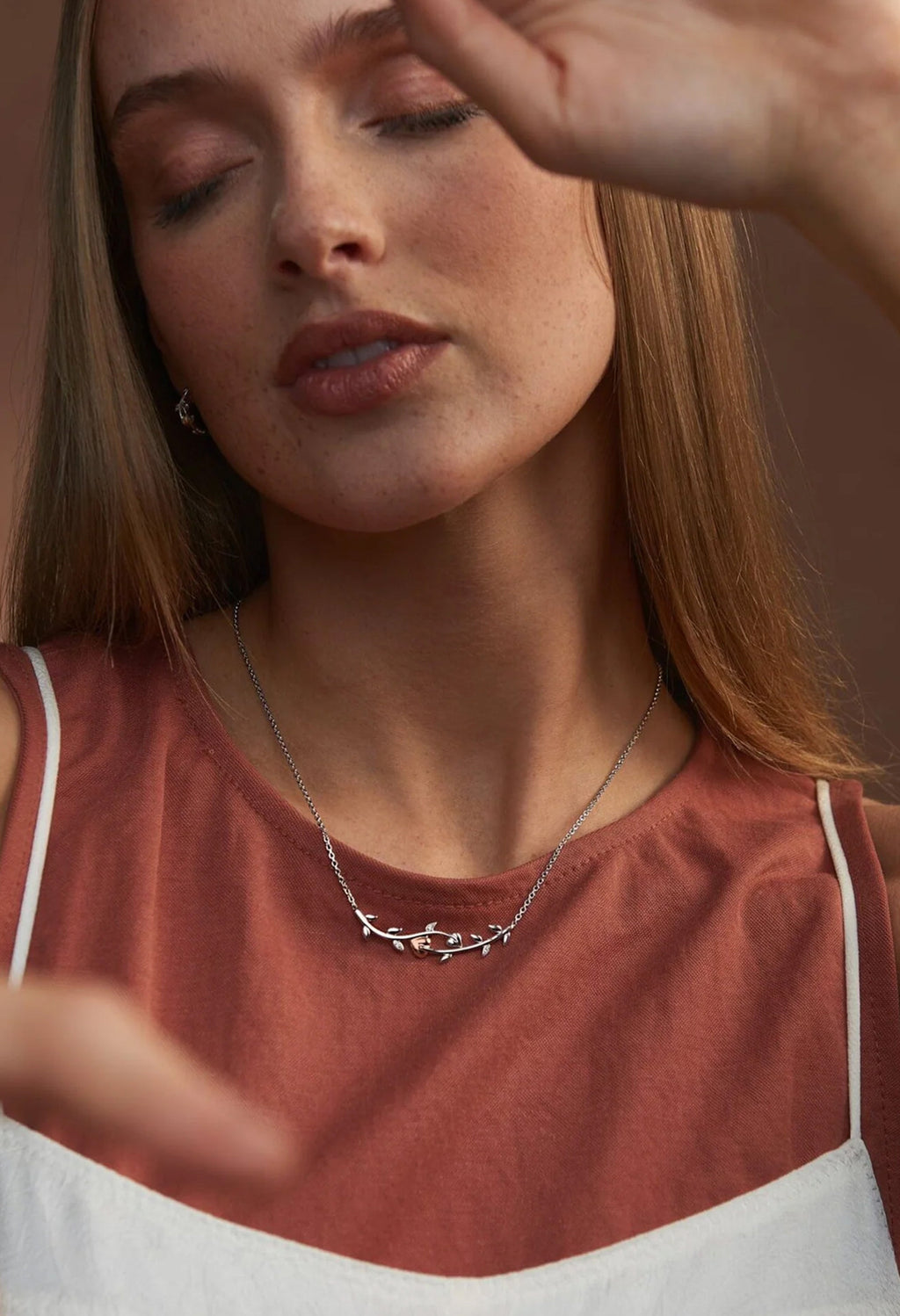 Model wearing a Clogau Tree Of Life necklace, showcasing the vine design in sterling silver jewelry.