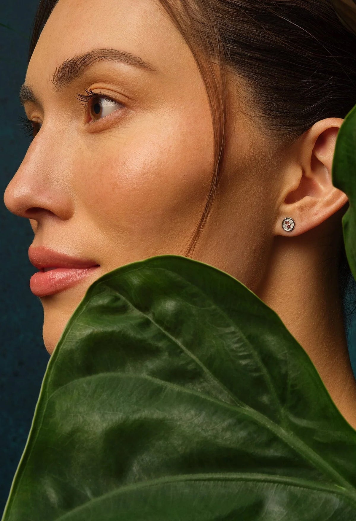 Sterling Silver Clogau stud earrings modeled on a woman, showcasing a glimpse of nature and style.