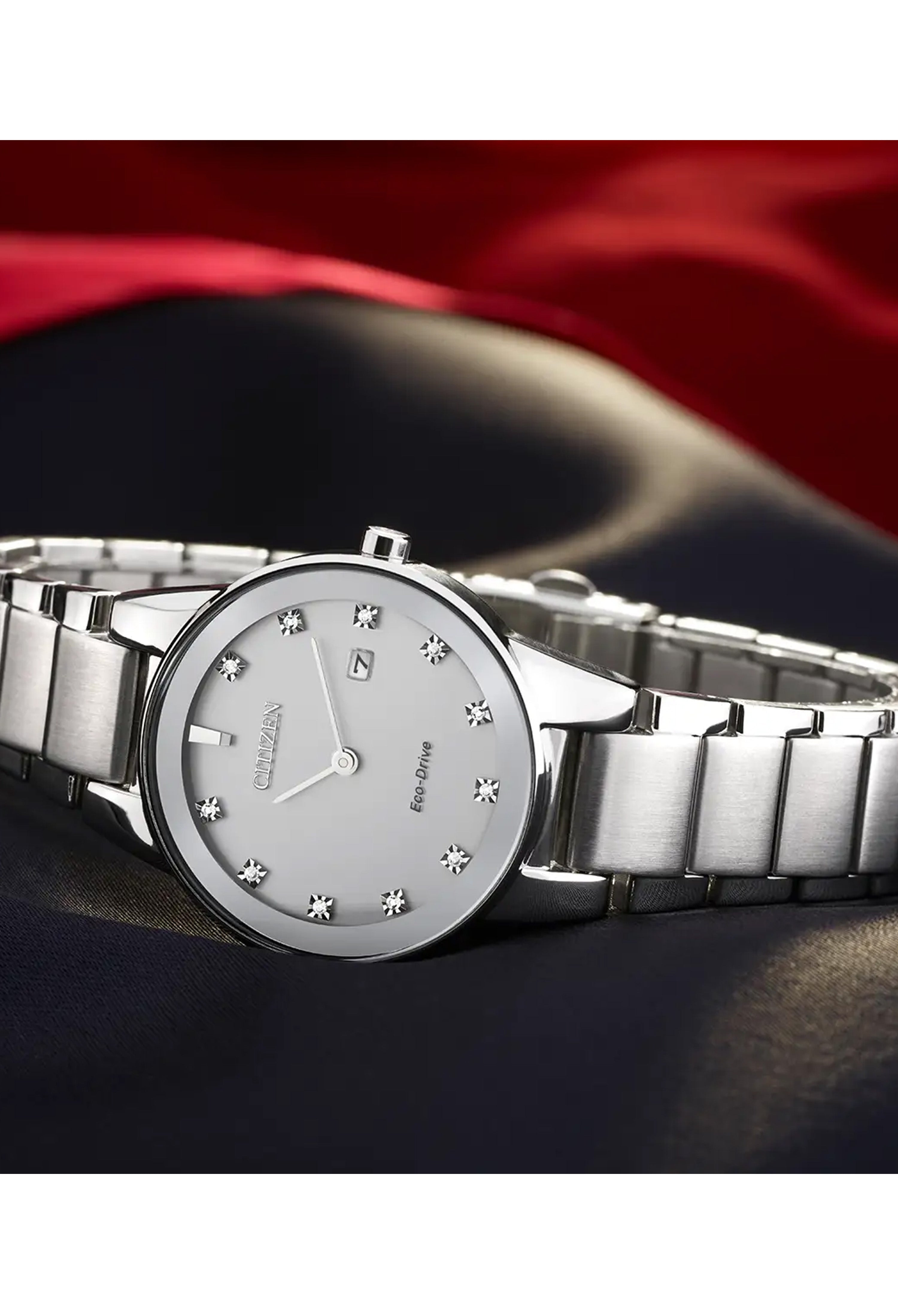 Elegant Citizen Eco-Drive women's watch featuring a diamond-accented dial and silver bracelet. A stylish timepiece for