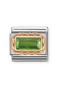 Nomination composable charm. Green baguette stone set in 9K rose gold on a steel link. Jewelry detail.