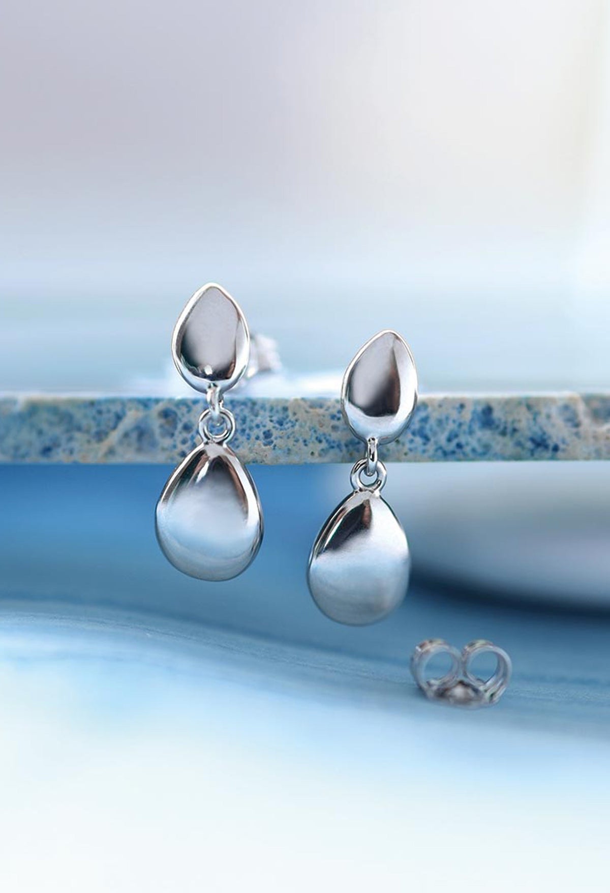 The Kit Heath Coast Pebble Stud With Silver Droplet Earrings, a silver metal earrings from Kit Heath, available at OD’s Jewellers in St Helens.