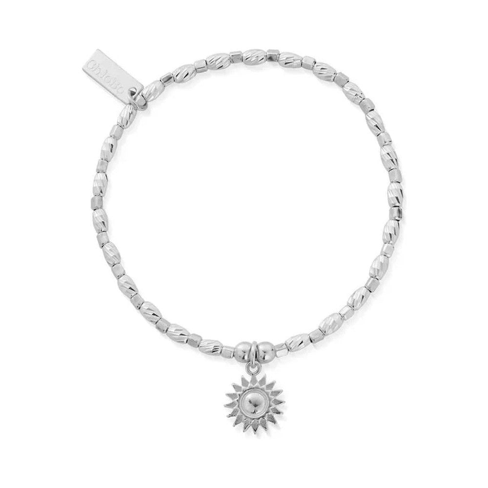 Silver beaded stretch bracelet with a sun charm.
