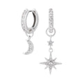 Silver Olivia Burton hoop earrings featuring celestial moon and star charms, studded with crystals.