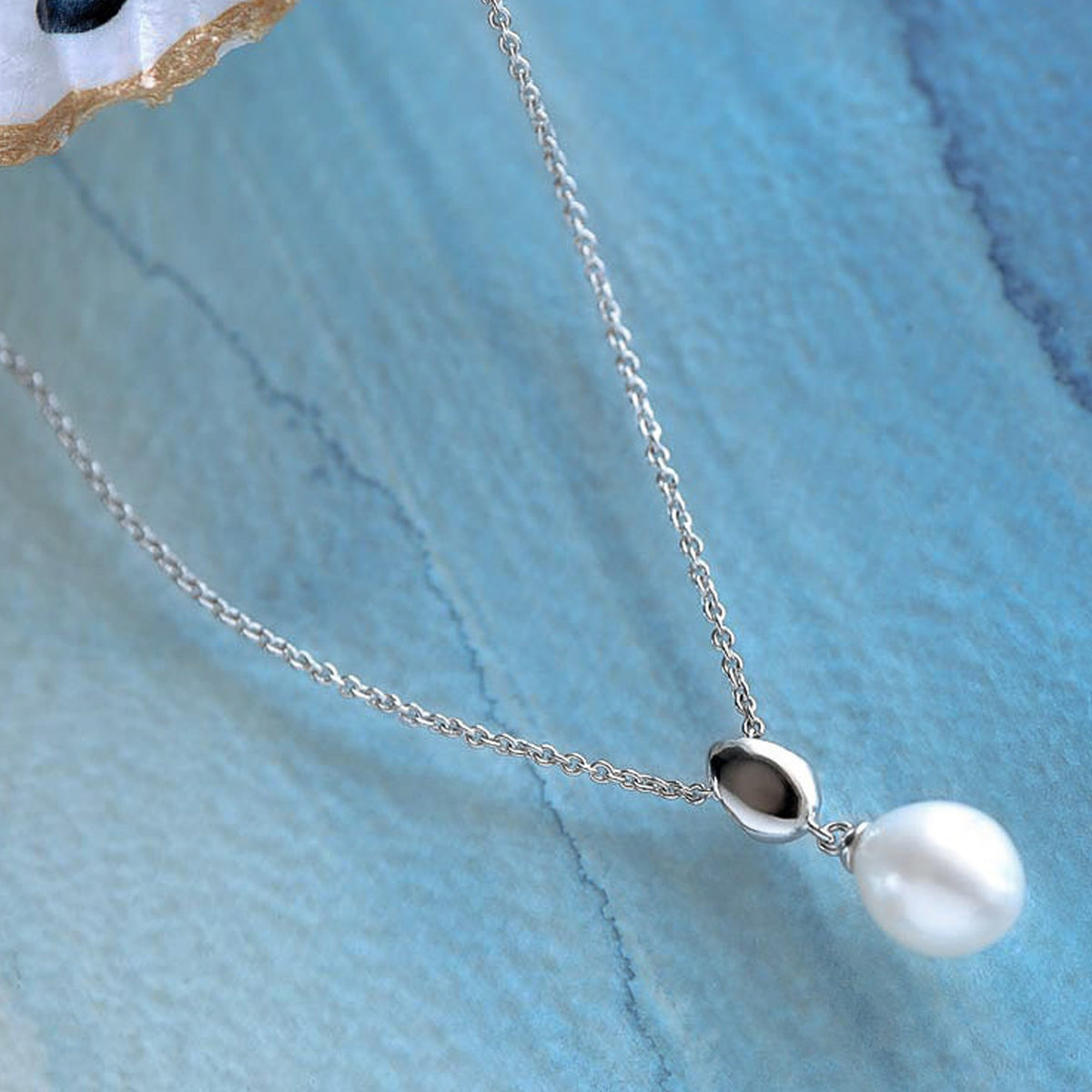 Elegant sterling silver necklace showcasing a Coast Pebble pearl drop pendant, ideal for adding a touch of sophistication to