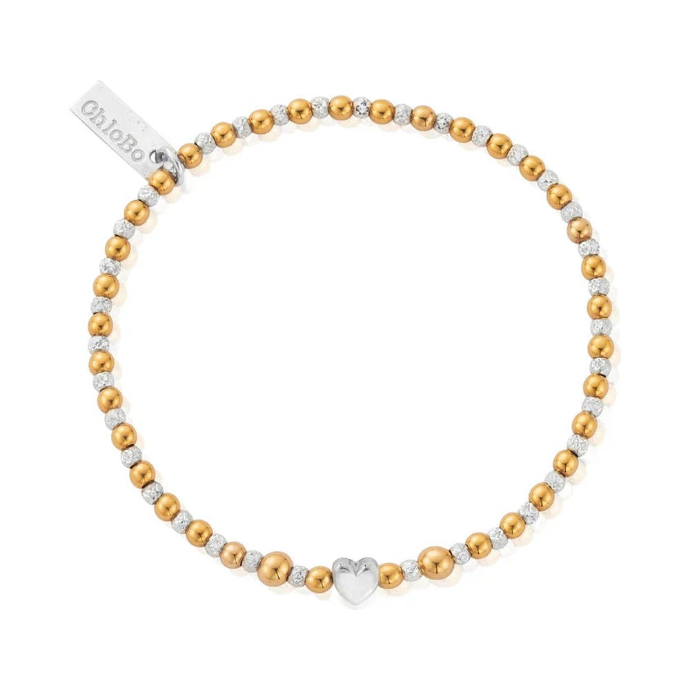 Gold and silver beaded bracelet with heart charm.
