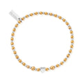Gold and silver beaded bracelet with heart charm.
