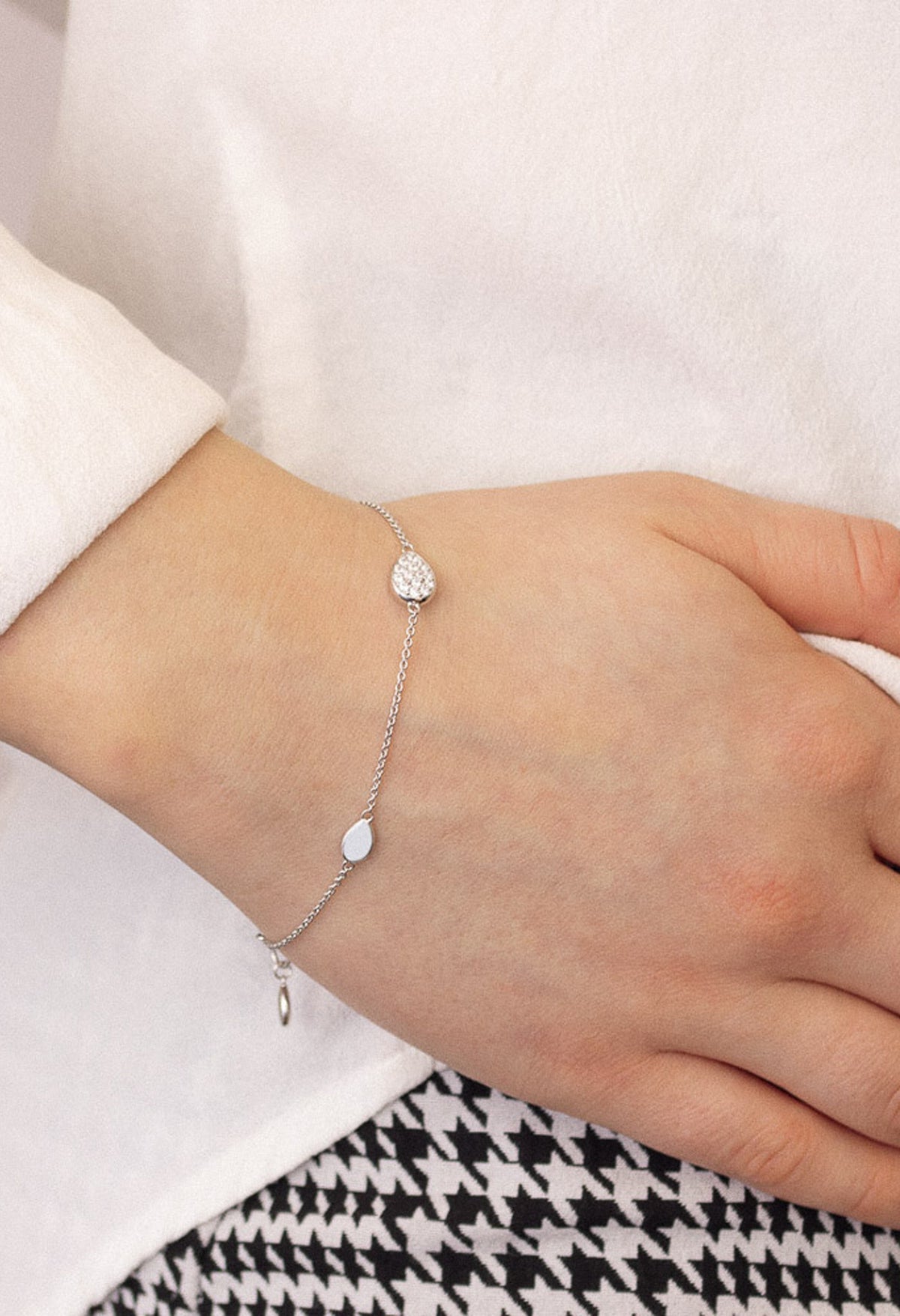 Elegant silver bracelet featuring pave CZ detail on wrist, showcasing Kit Heath Coast Pebble design.