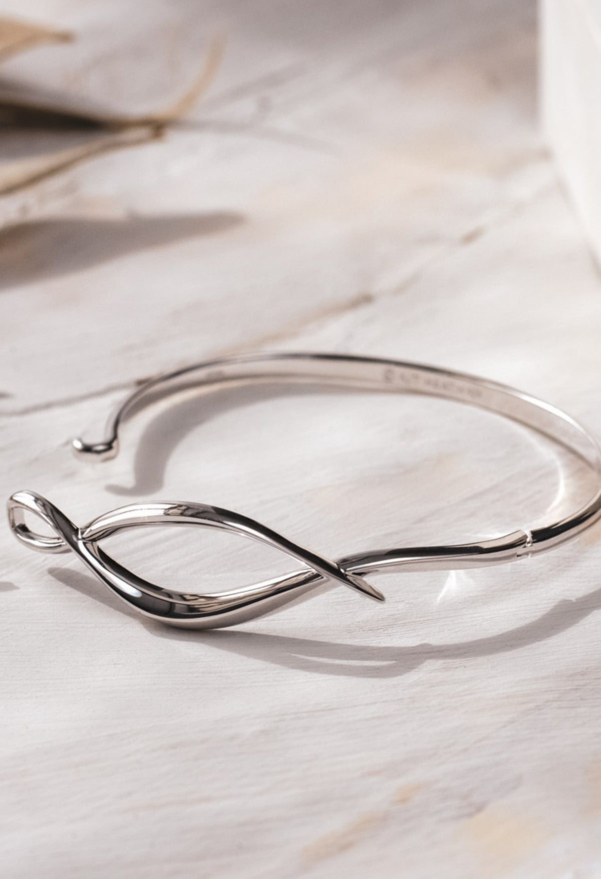 The Kit Heath Entwine Twine Twist Hinged Bangle, a silver bracelet from Kit Heath, available at OD’s Jewellers in St Helens.