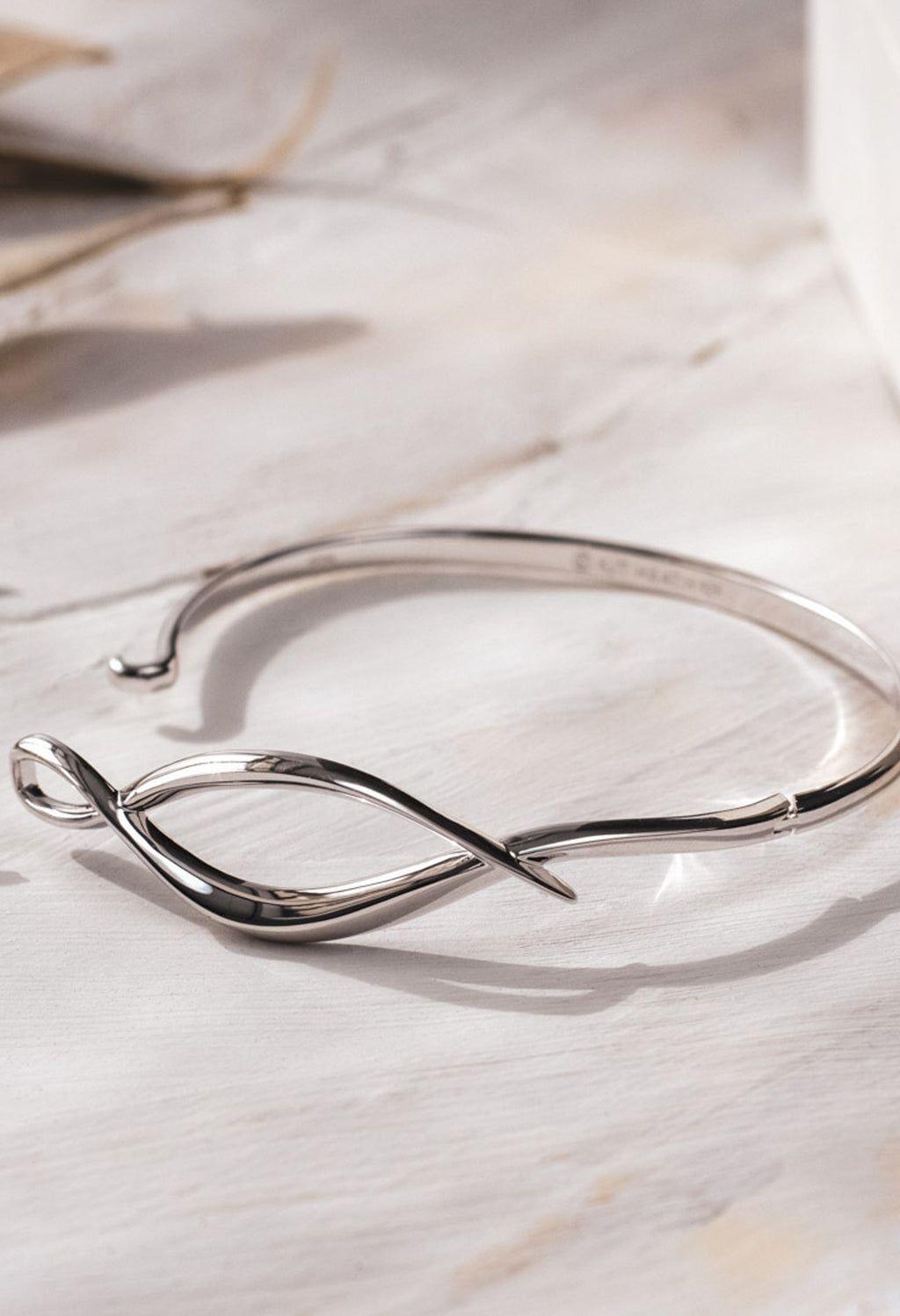 The Kit Heath Entwine Twine Twist Hinged Bangle, a silver bracelet from Kit Heath, available at OD’s Jewellers in St Helens.