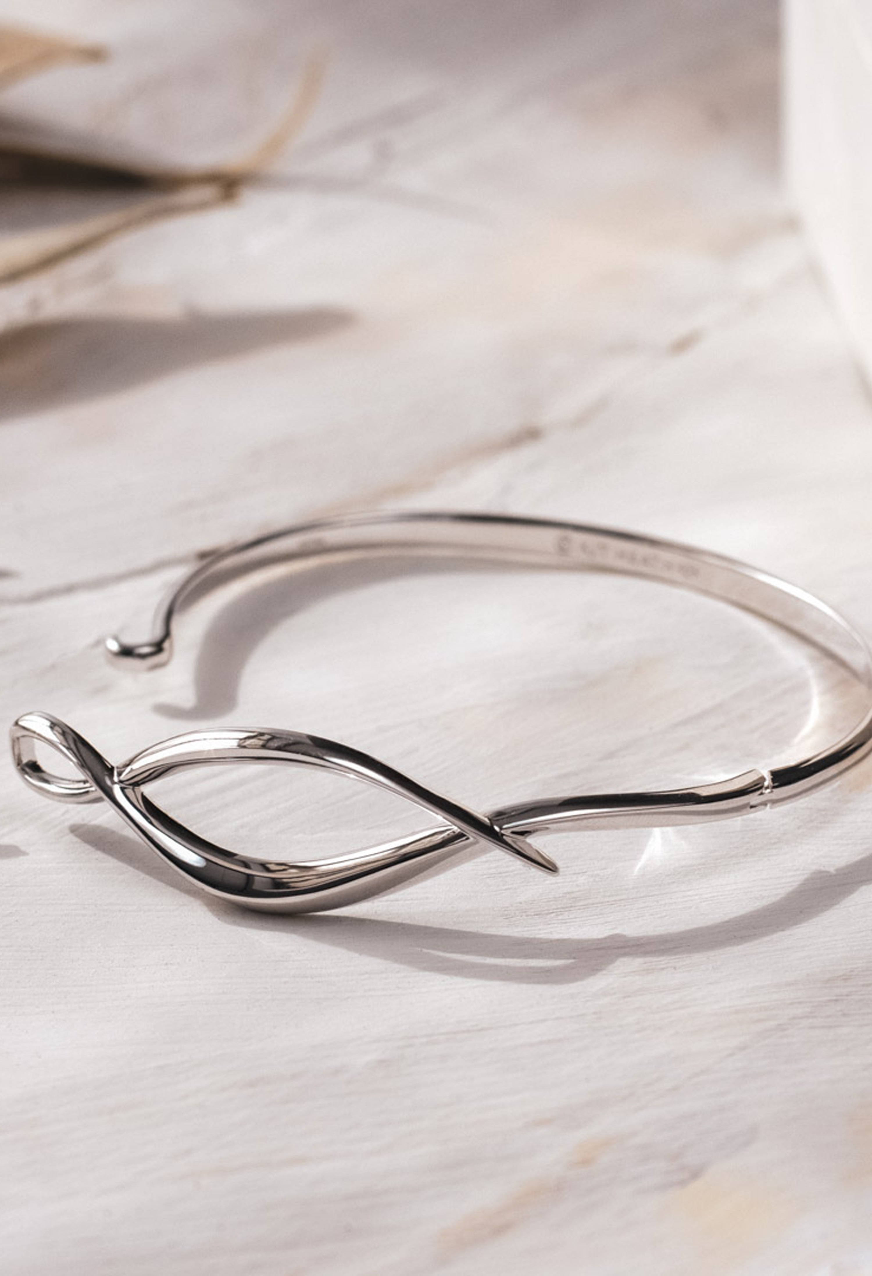 The Kit Heath Entwine Twine Twist Hinged Bangle, a silver bracelet from Kit Heath, available at OD’s Jewellers in St Helens.