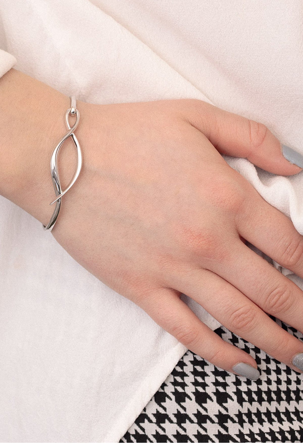 The Kit Heath Entwine Twine Twist Hinged Bangle, a silver bracelet from Kit Heath, available at OD’s Jewellers in St Helens.