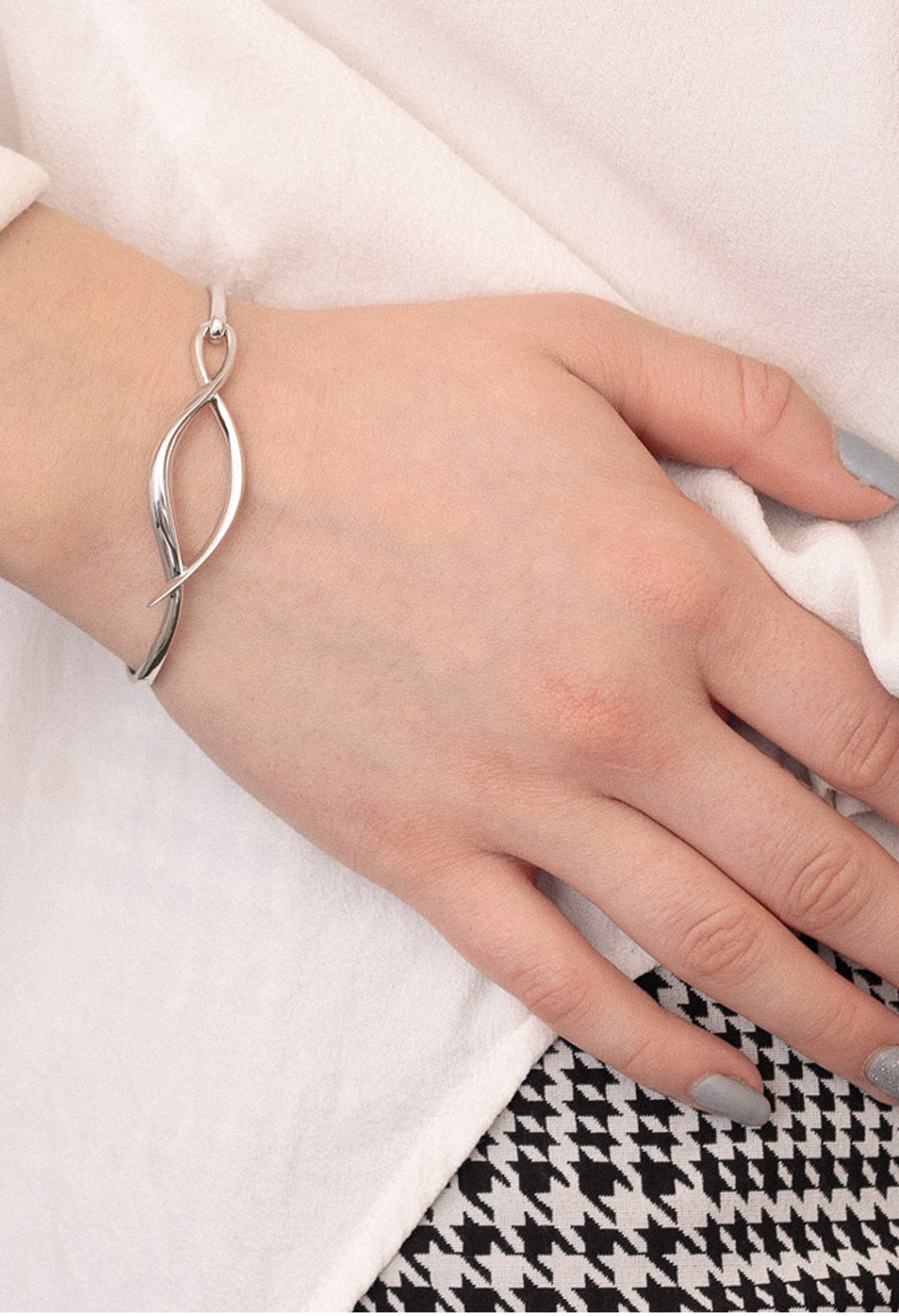 The Kit Heath Entwine Twine Twist Hinged Bangle, a silver bracelet from Kit Heath, available at OD’s Jewellers in St Helens.