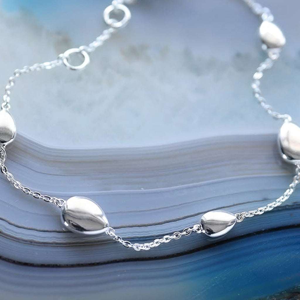 Kit Heath Coast Pebble Bracelet on display; showcases the polished silver pebble design and delicate chain.