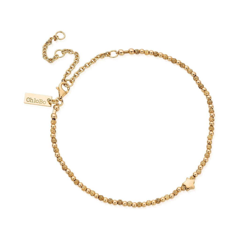 Gold-plated ChloBo star anklet showcasing delicate beadwork and signature branded tag; a stylish jewelry accessory.