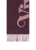 A close-up of a dark plum purple scarf with a large light pink stylized Vivienne printed on it and fringed ends, shown against a white background.