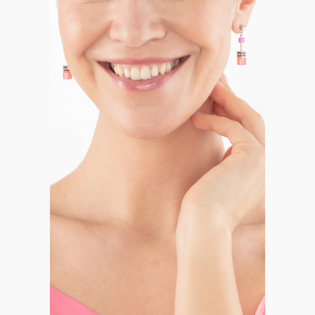 The Coeur De Lion GeoCube Viva Magenta Earrings, a magenta stainless steel earrings from Coeur De Lion, available at OD’s Jewellers in St Helens.