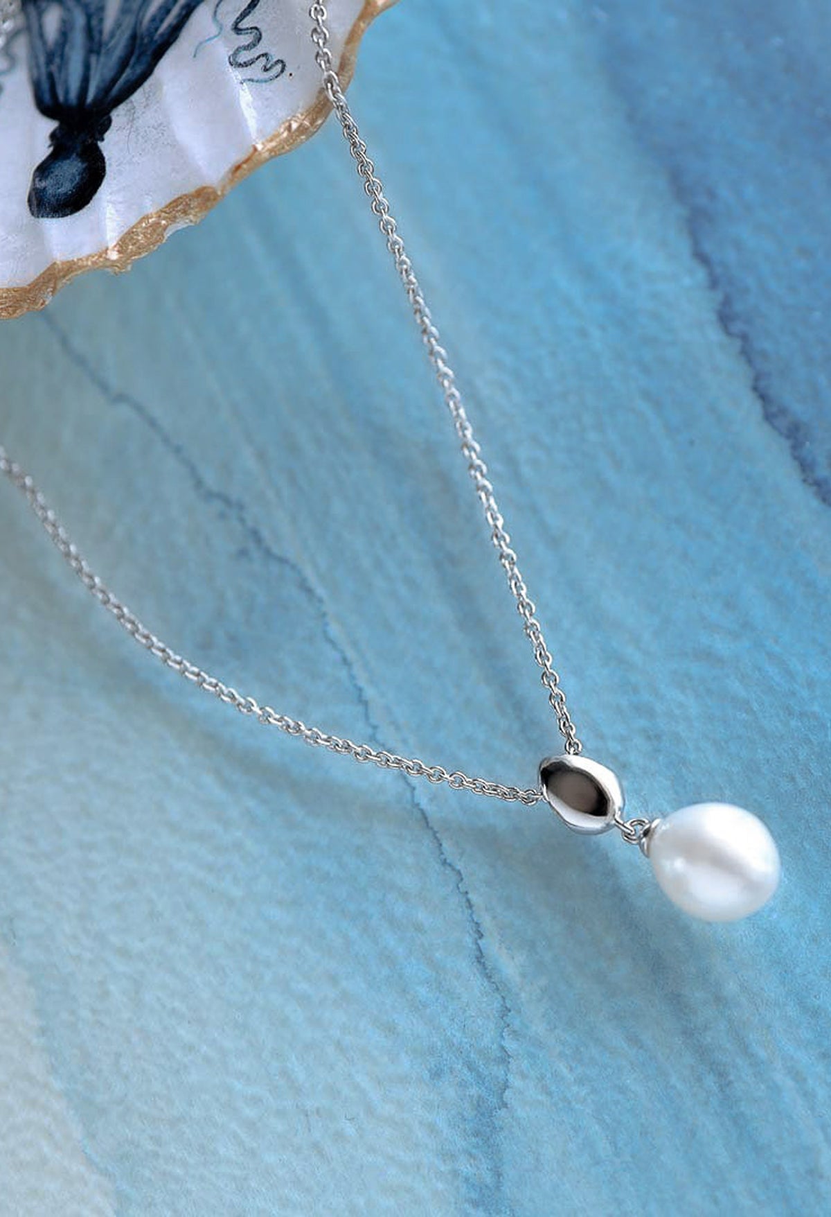 Elegant sterling silver necklace showcasing a Coast Pebble pearl drop pendant, ideal for adding a touch of sophistication to