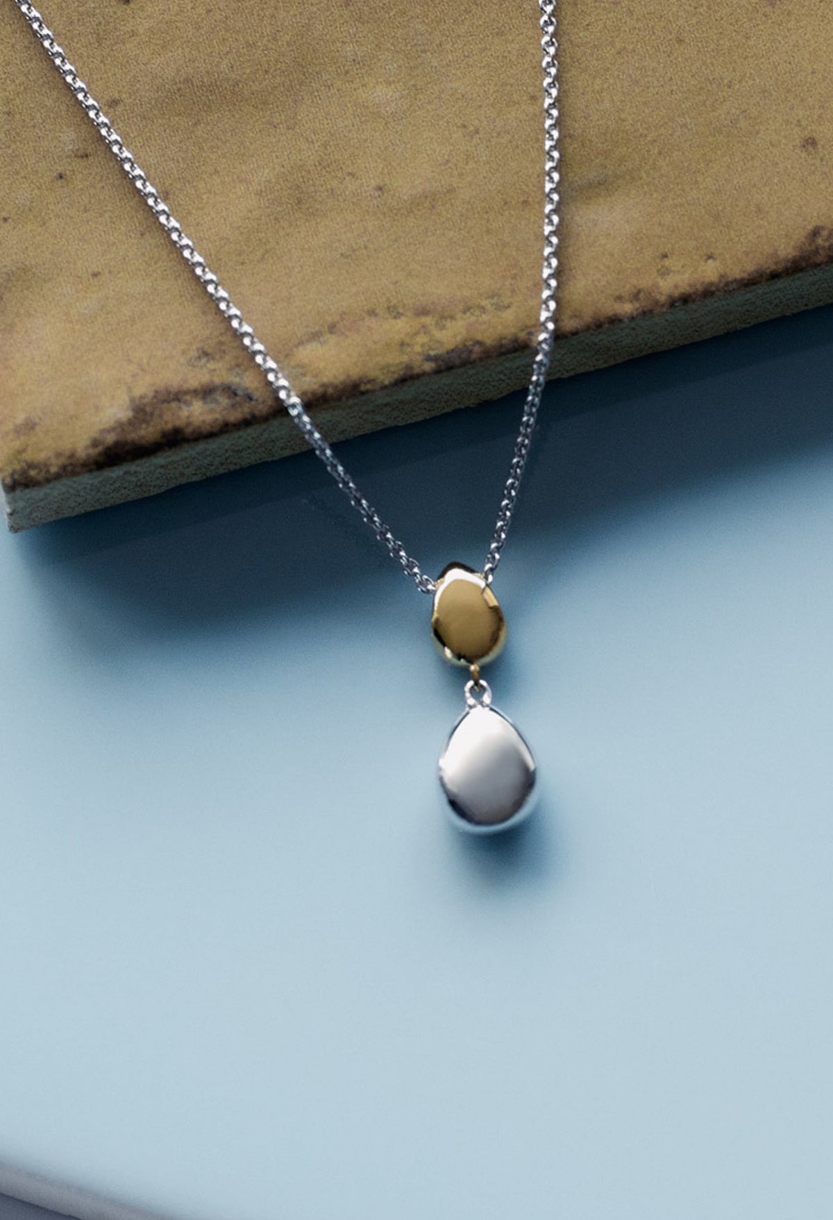 The Kit Heath Coast Pebble Golden Double Droplet Necklace, a gold plated necklace from Kit Heath, available at OD’s Jewellers in St Helens.