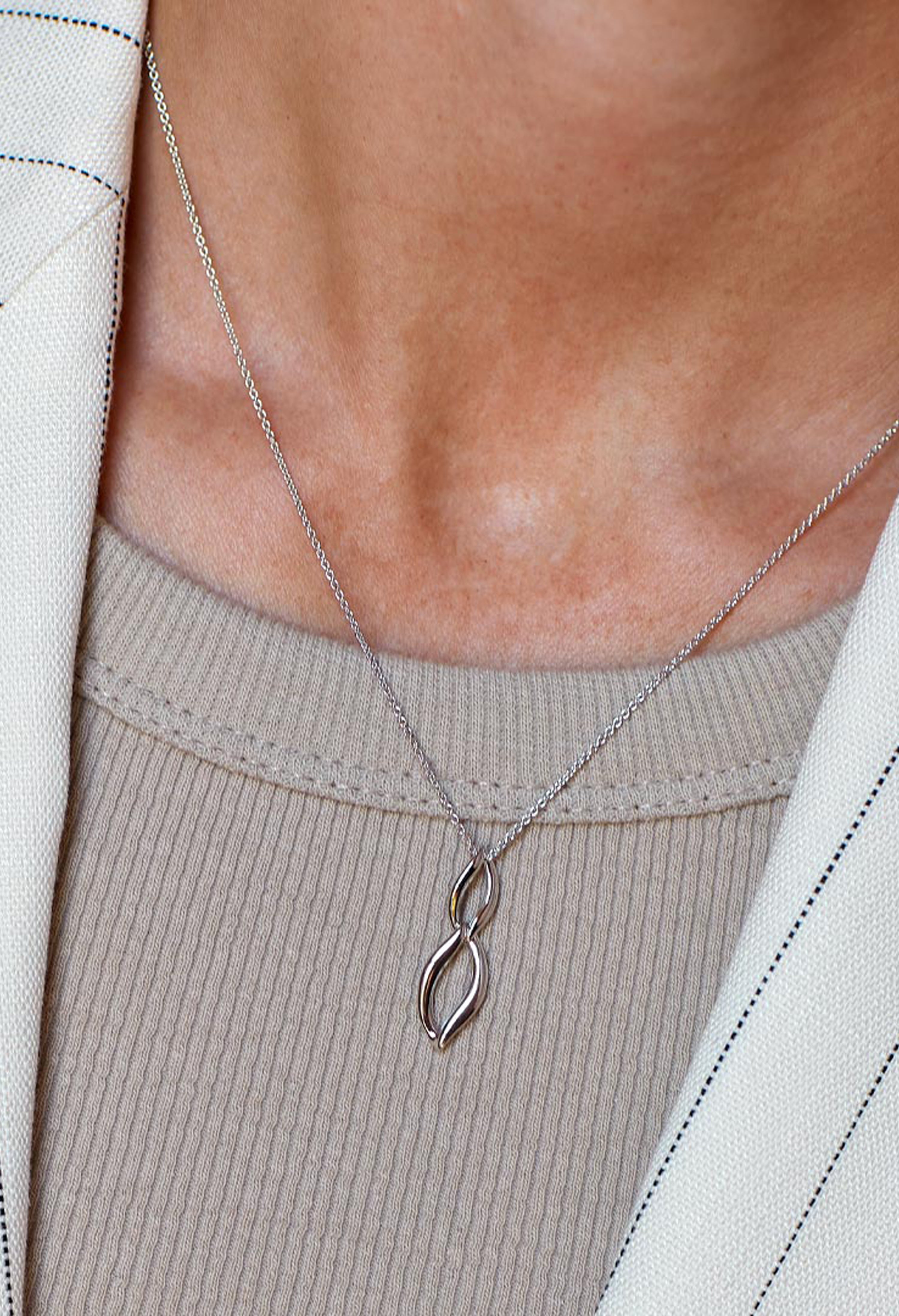 Close-up of Kit Heath Entwine necklace showcasing its elegant double link design on a silver chain, highlighting its fine