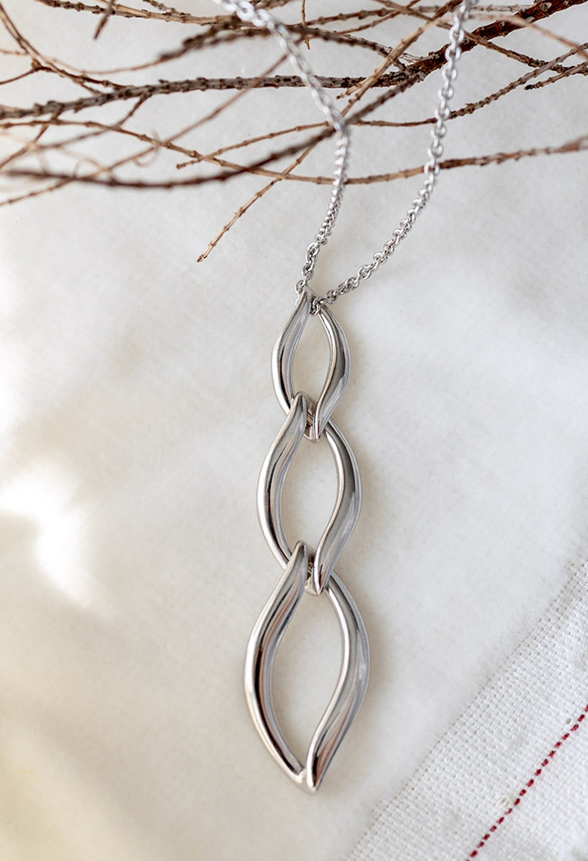 The Kit Heath Entwine Twine Trio Link Necklace, a silver necklace from Kit Heath, available at OD’s Jewellers in St Helens.