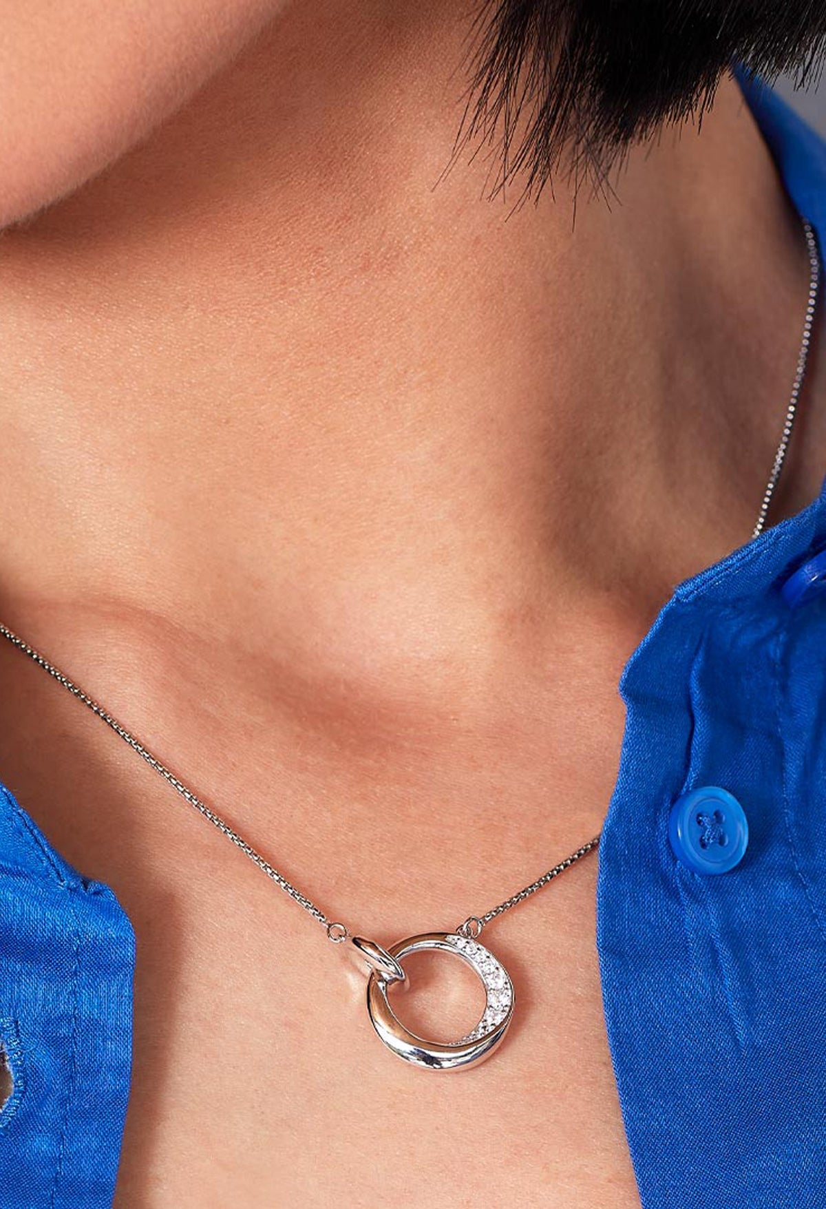 Close-up showcasing Kit Heath Bevel Cirque necklace. Silver chain, circle pendant with pave CZ detail. Perfect jewelry gift.