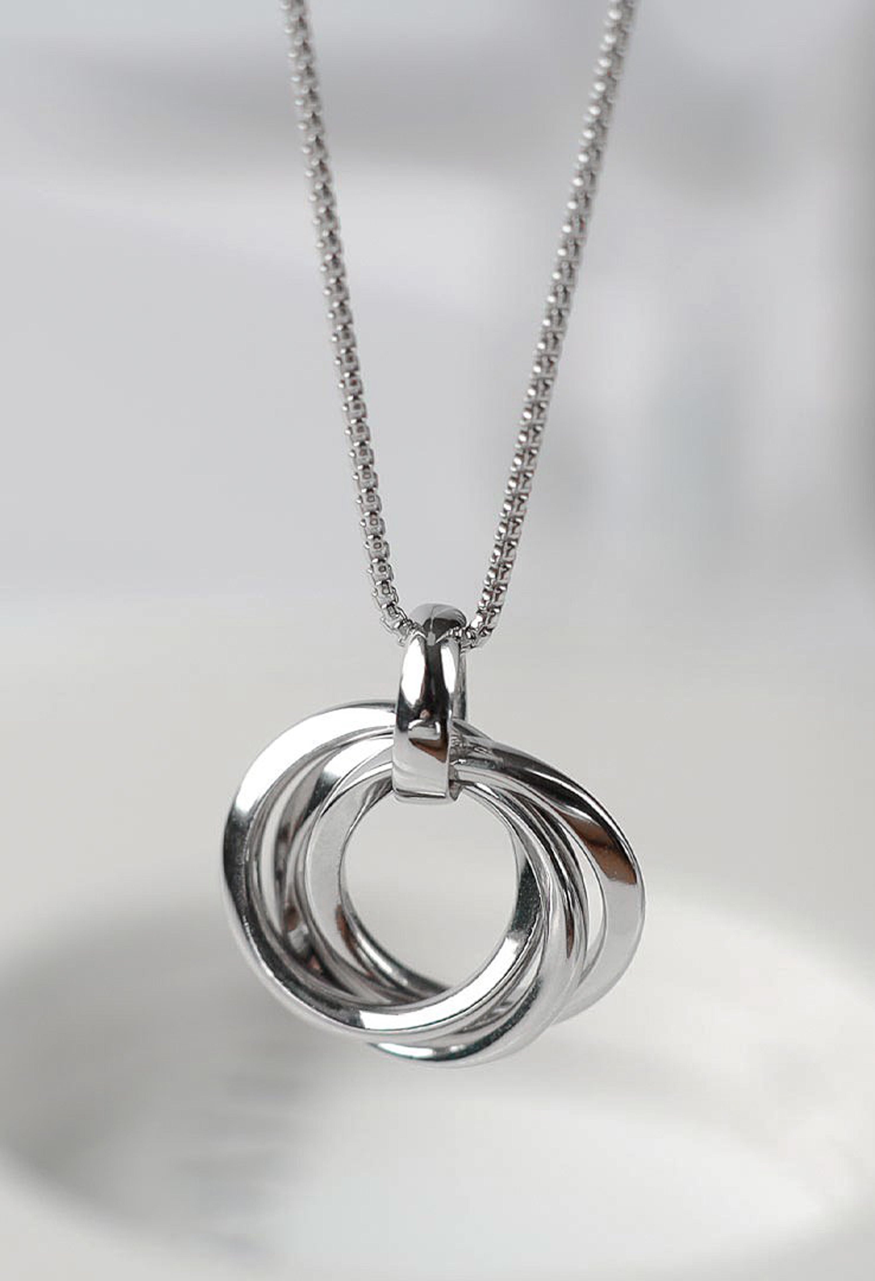 Silver Kit Heath Trilogy Necklace showcasing the interconnected rings pendant with rhodium plating on a delicate chain.