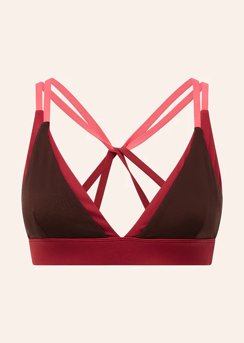 Brown and red sports bra with pink straps on a beige background