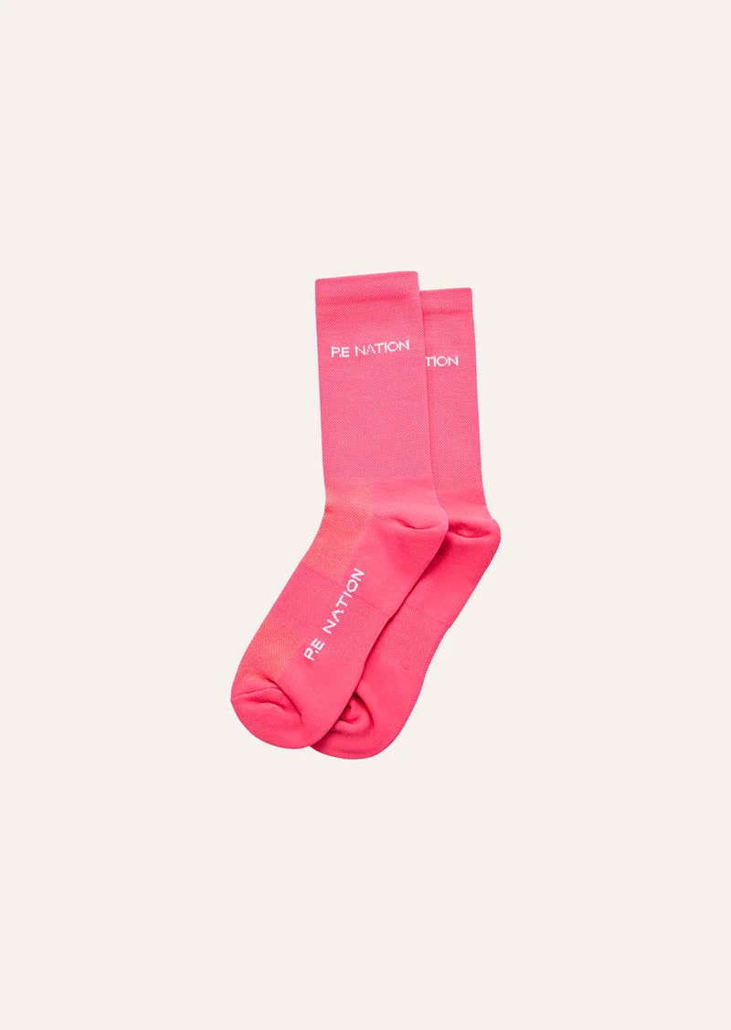 Pair of pink socks with text on a light beige background