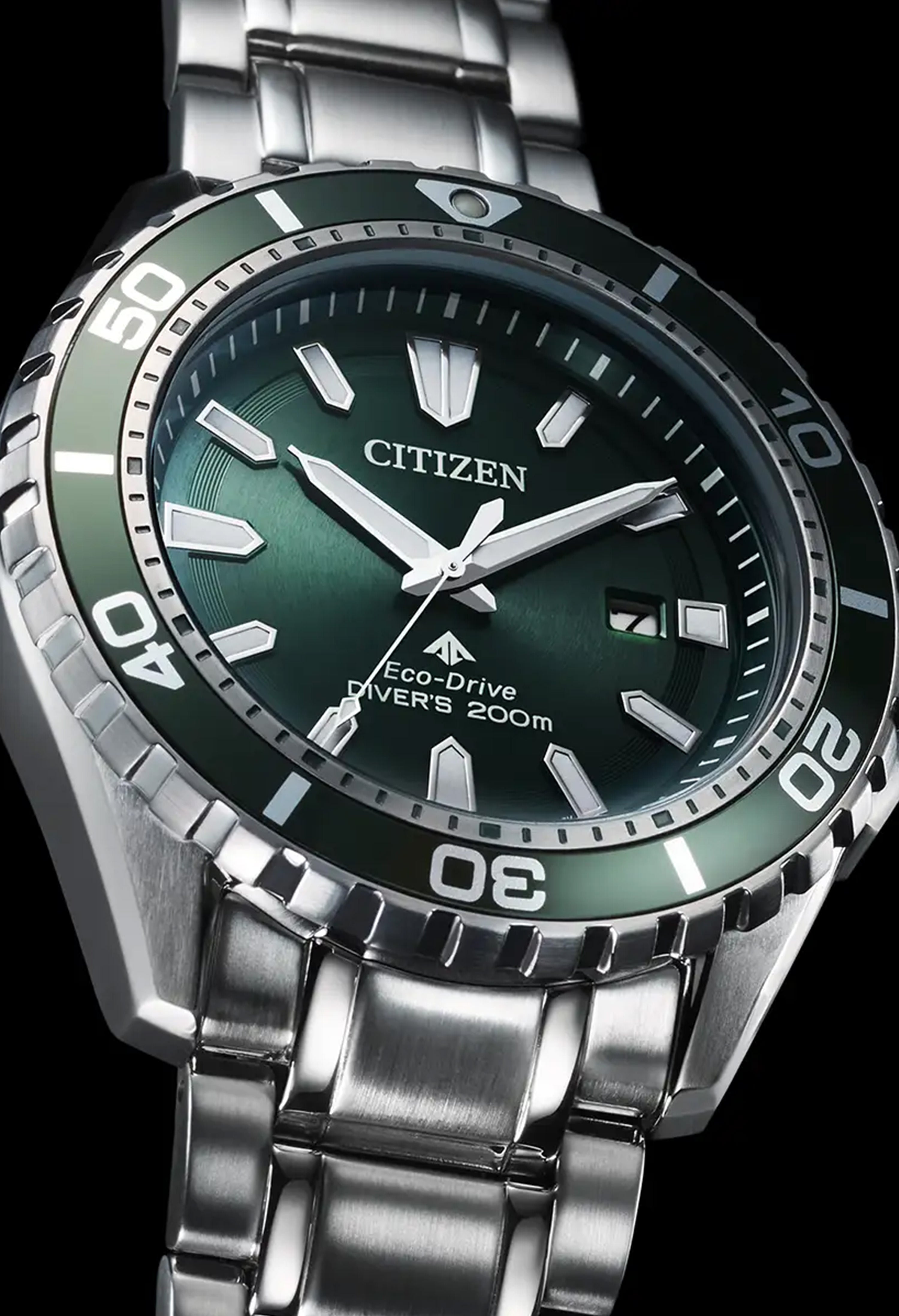 Close-up of the Citizen Eco-Drive Promaster Diver watch. Features a green dial, rotating bezel, and stainless steel band.