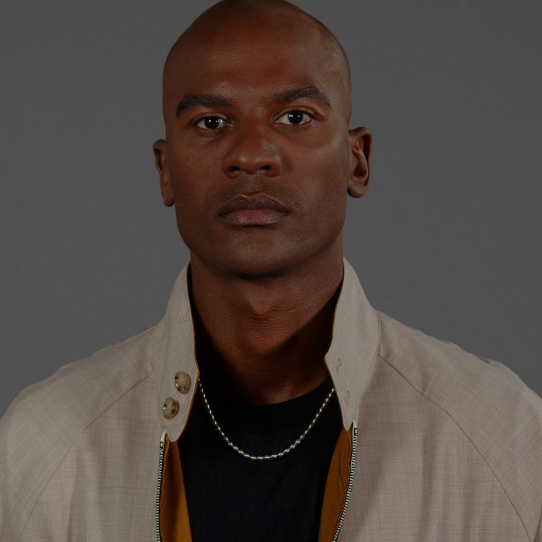 Close-up of a man wearing a BOSS Sphere metal necklace, showcasing stainless steel jewelry design and stylish presentation.