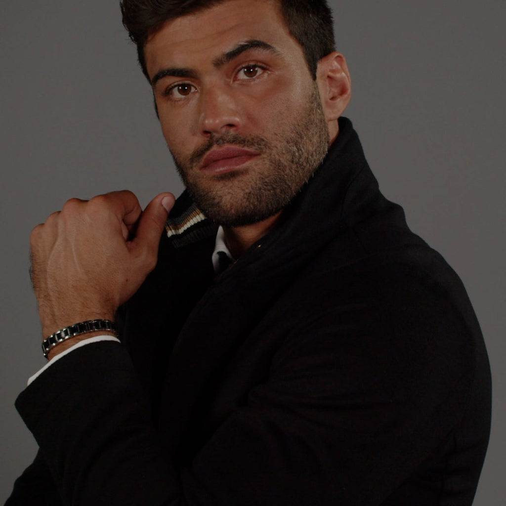 Man wearing BOSS metal link bracelet. Stylish men's jewelry for a refined, modern look.