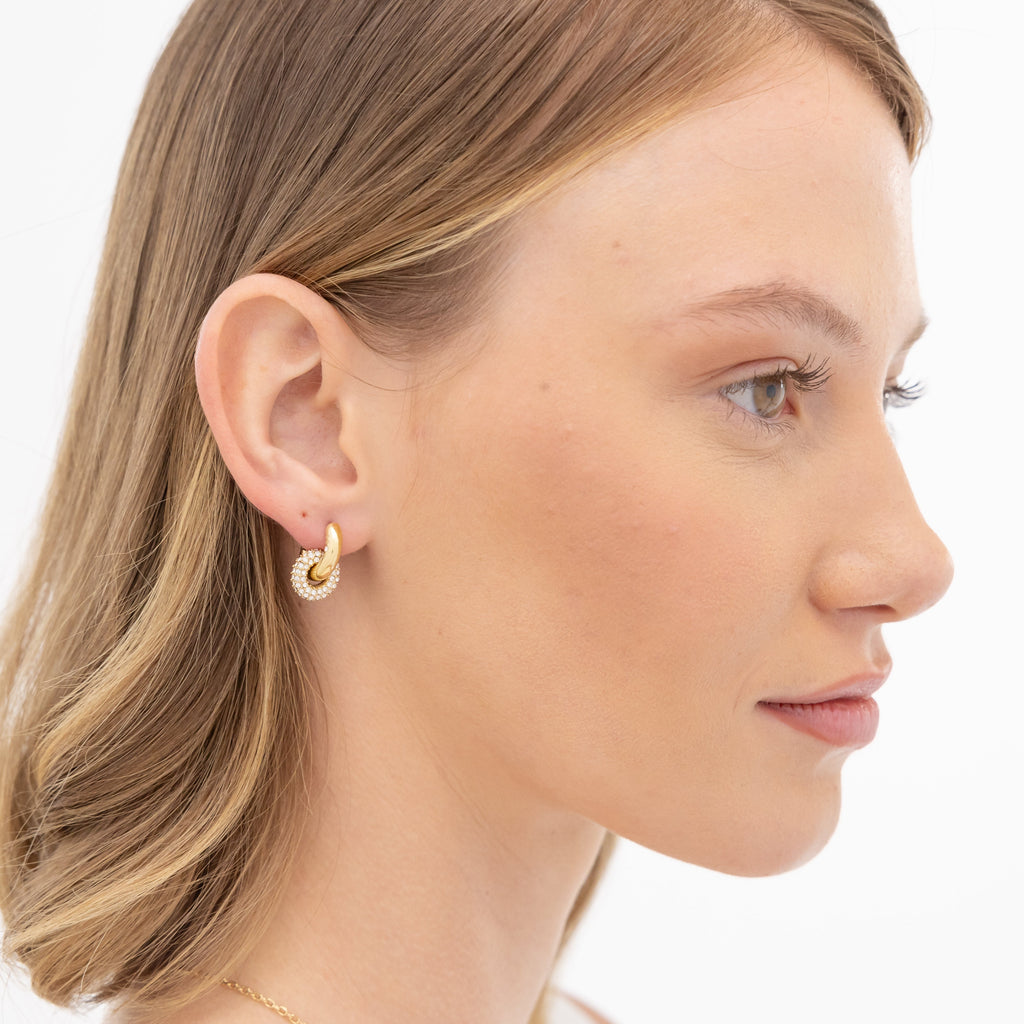 Profile of a woman wearing hoop earrings.