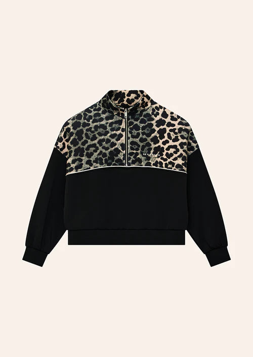 Black and leopard print jacket on a beige background
