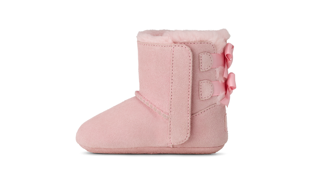Pink baby bootie with a bow on a white background