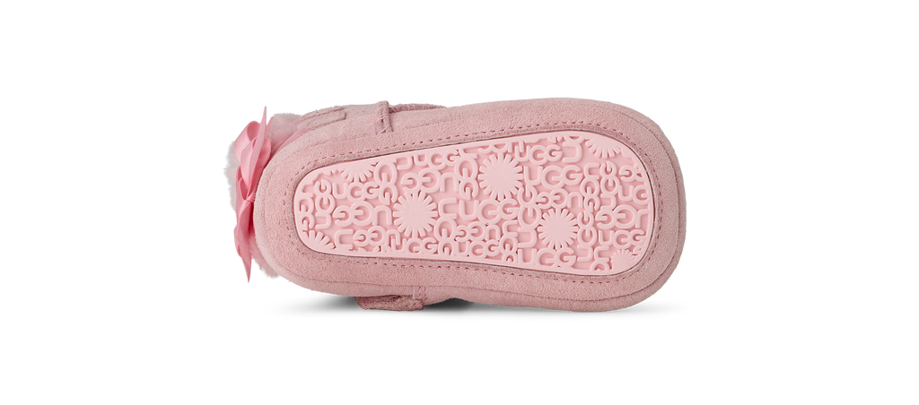 Pink baby shoe with a soft sole on a white background
