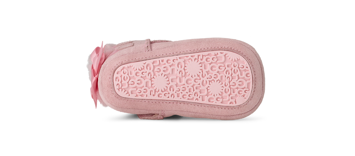 Pink baby shoe with a soft sole on a white background