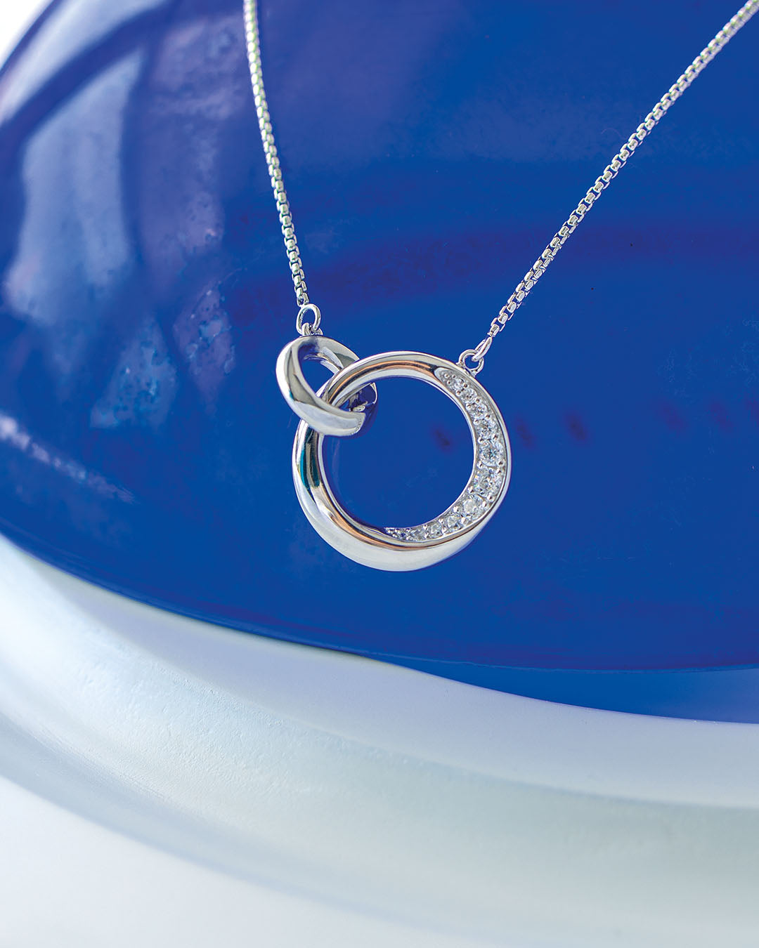 Bevel Cirque Link Pavé Necklace on a styled background