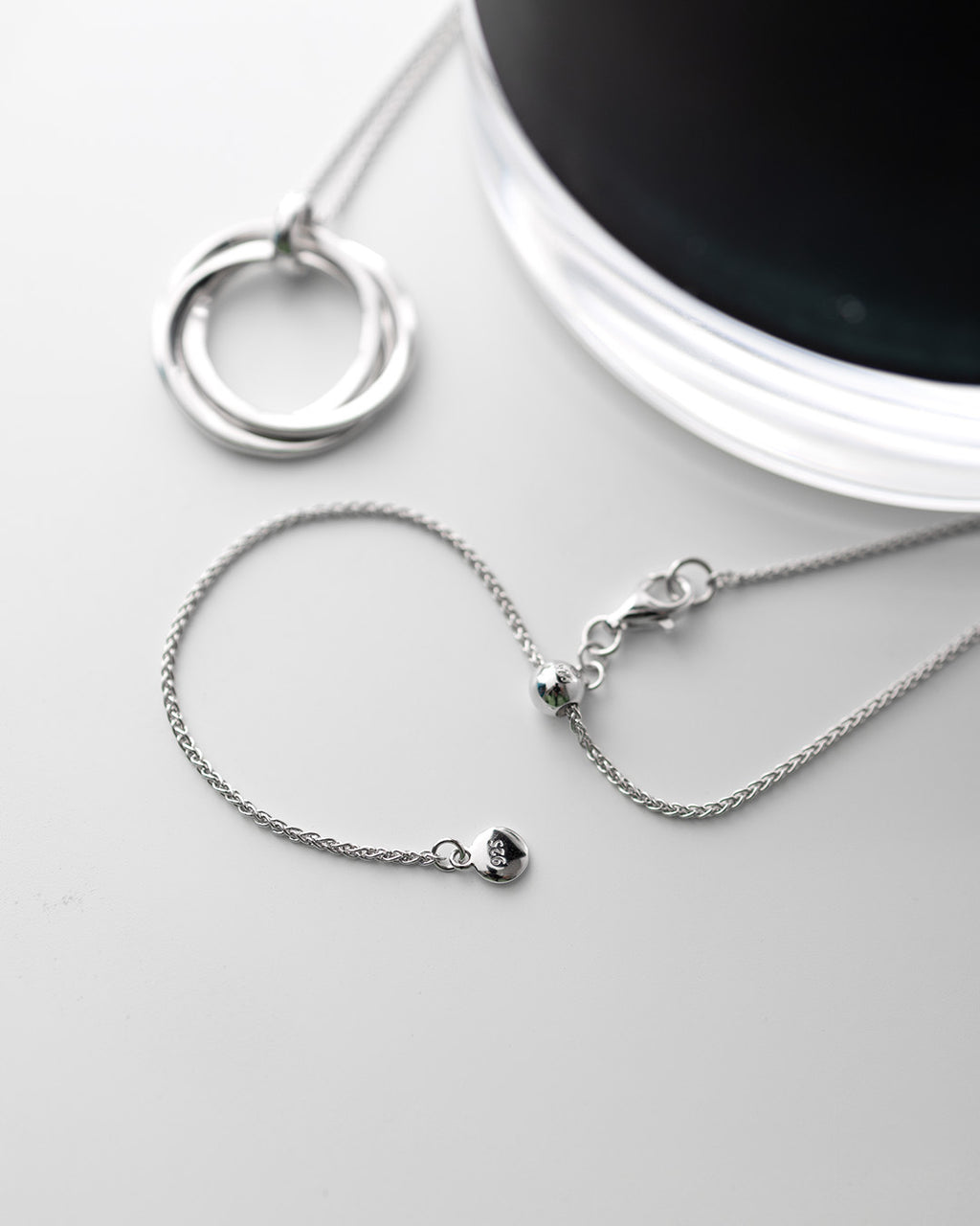 Bevel Trilogy Grande Link Slider Necklace on a styled background