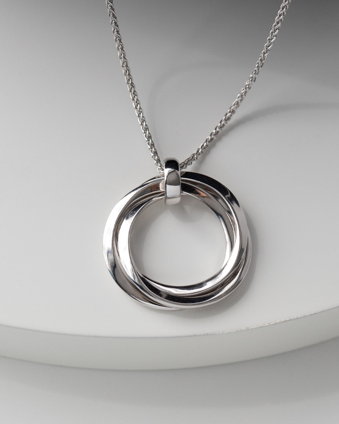 Bevel Trilogy Grande Link Slider Necklace on a styled background