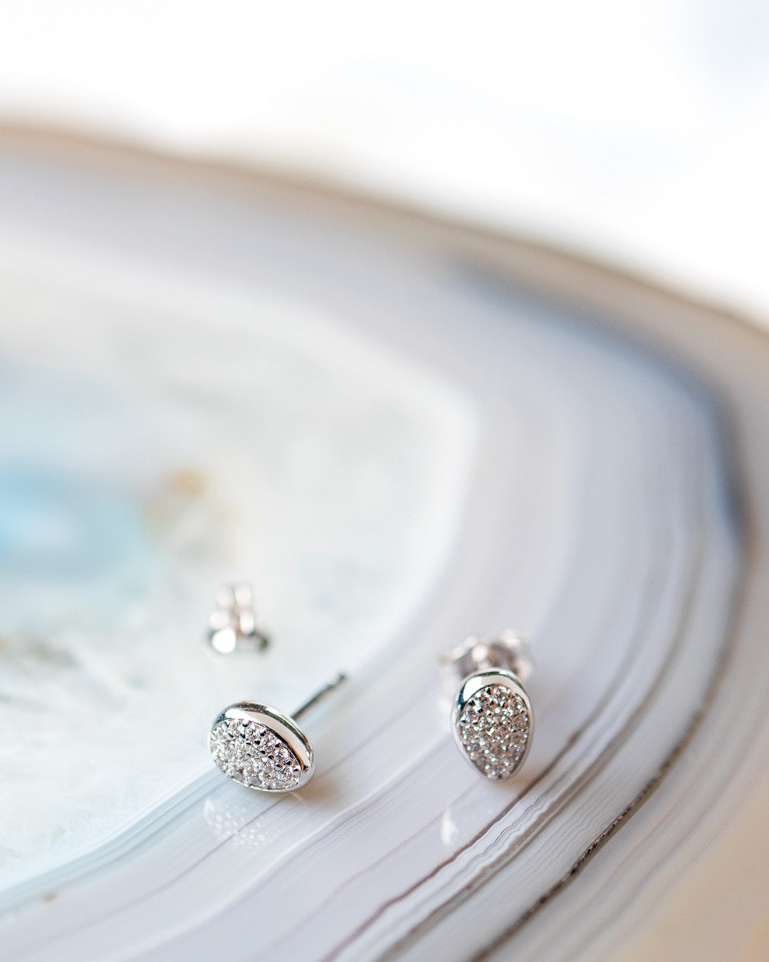 Coast Pebble Glisten Pavé Stud Earrings on a styled background