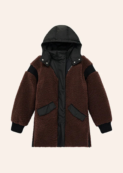 Brown coat with black accents on a beige background