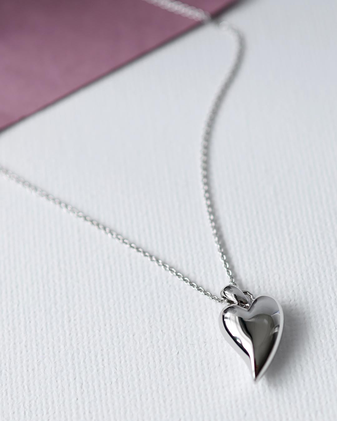 Desire Cherish Midi Heart Necklace on a styled background