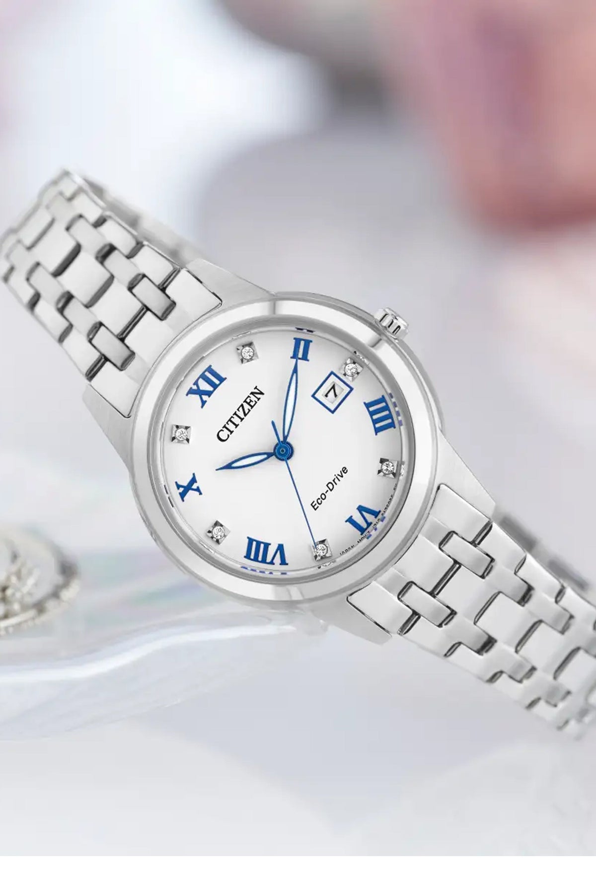 Citizen ladies' Eco-Drive watch with silver bracelet & white face featuring blue roman numerals & crystal accents.