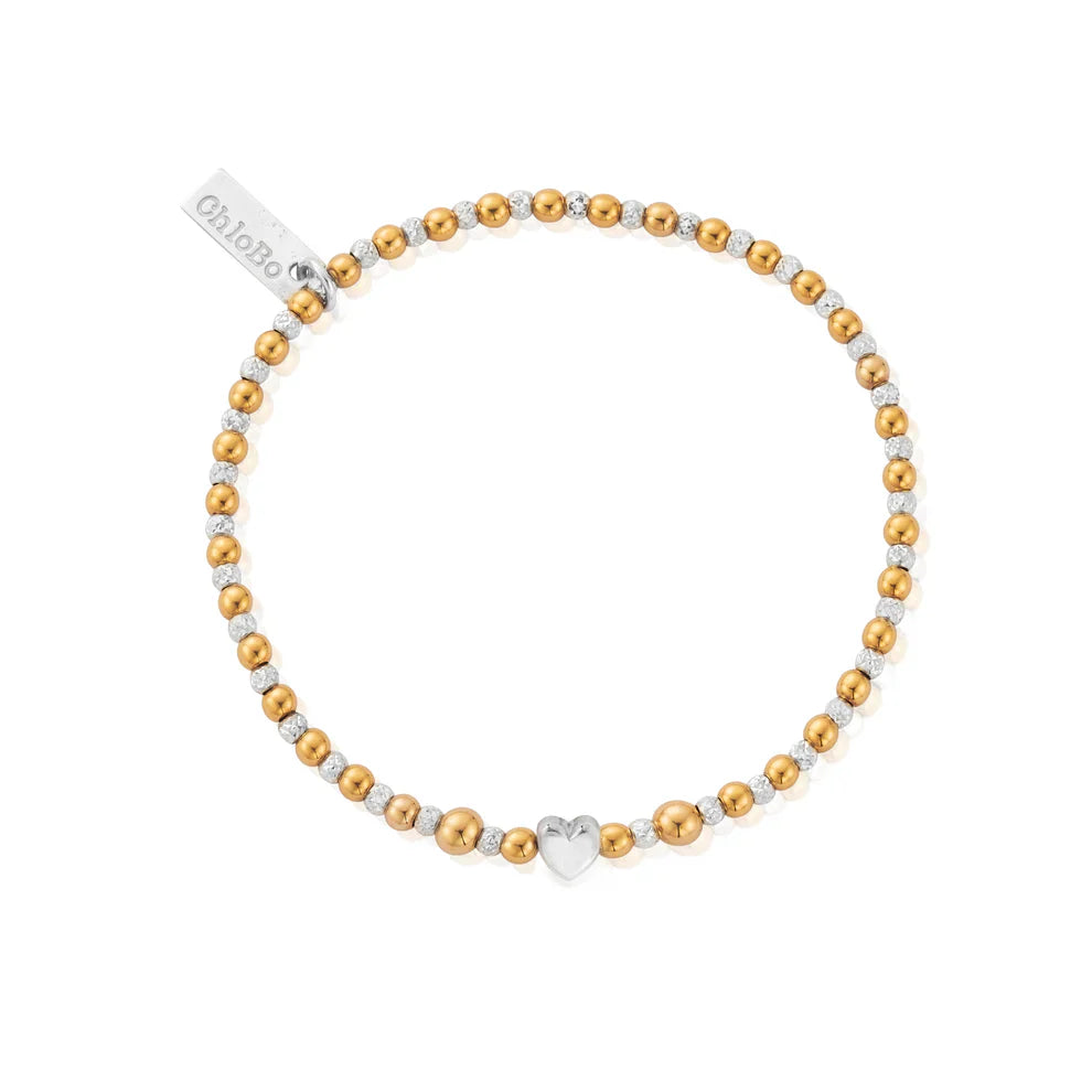 Gold and silver beaded bracelet with heart charm.
