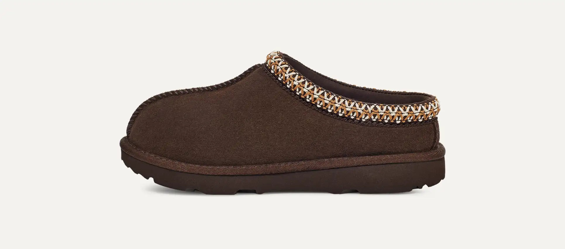 Brown slipper with decorative trim on a white background