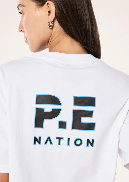 Person wearing a white t-shirt with 'P.E. Nation' logo on the back.