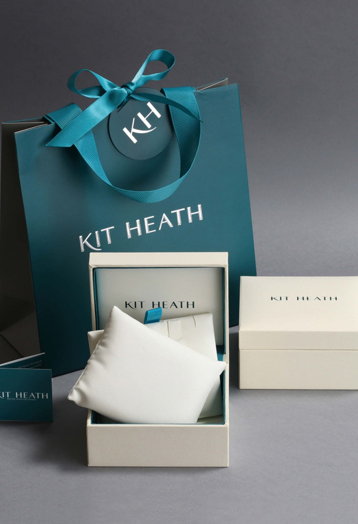 Kit Heath jewelry packaging: necklace box, gift bag, and card showcase luxury unboxing experience.