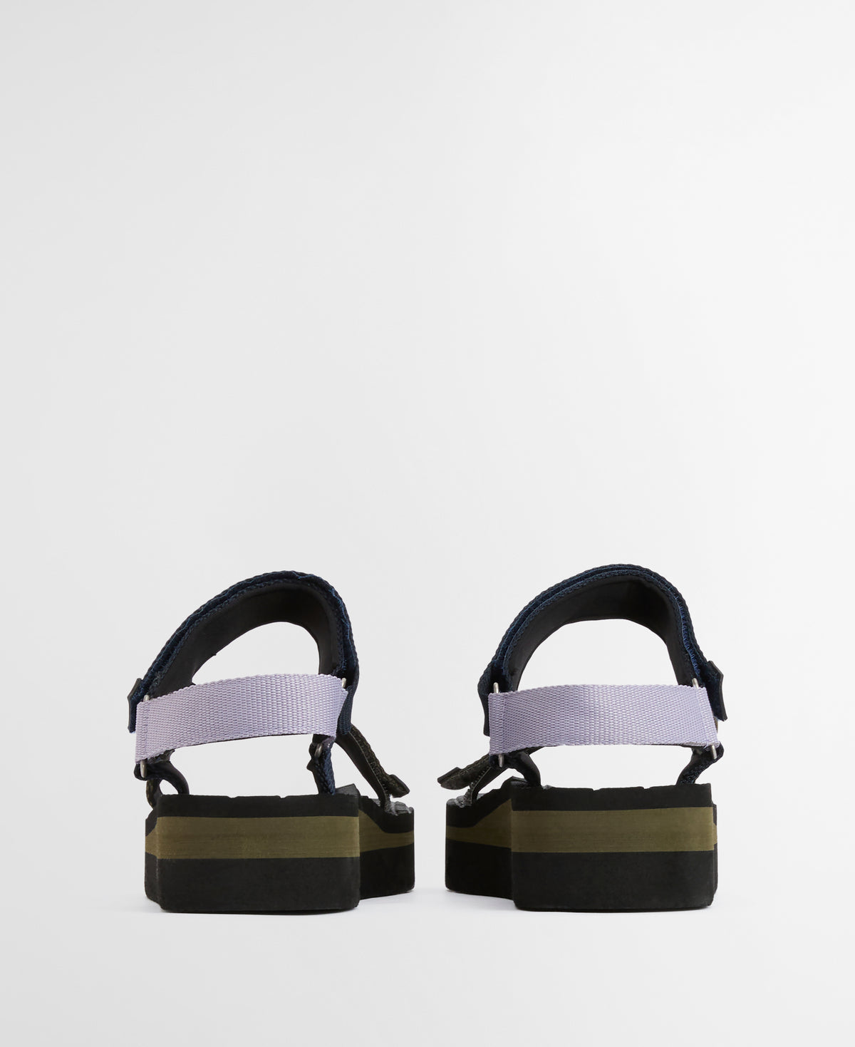 Pair of black sandals with a white strap on a light gray background