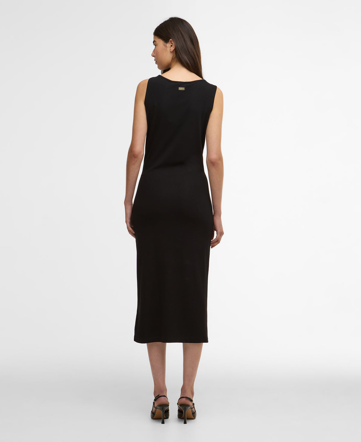 Woman wearing a black sleeveless dress on a white background