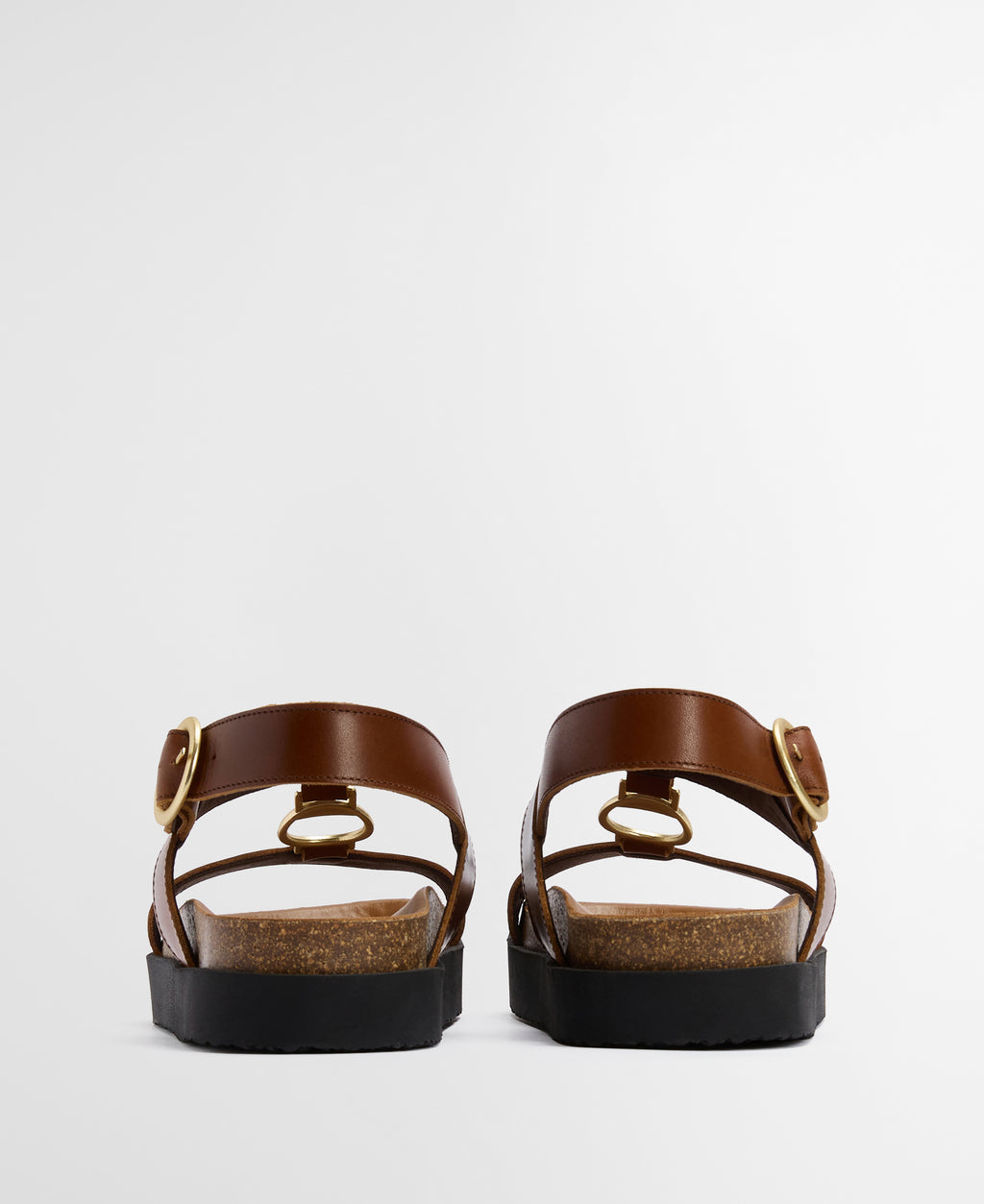Pair of brown sandals with straps on a light gray background